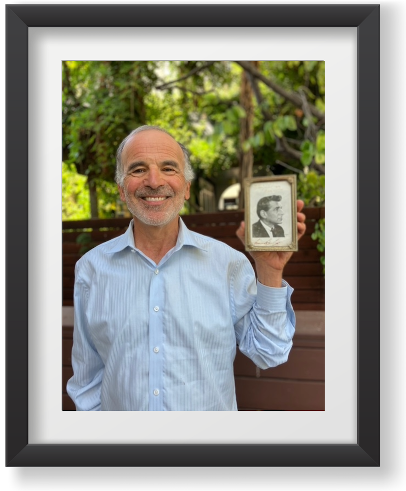 Ben Simon in a picture frame holding a framed photo of Leonard Bernstein