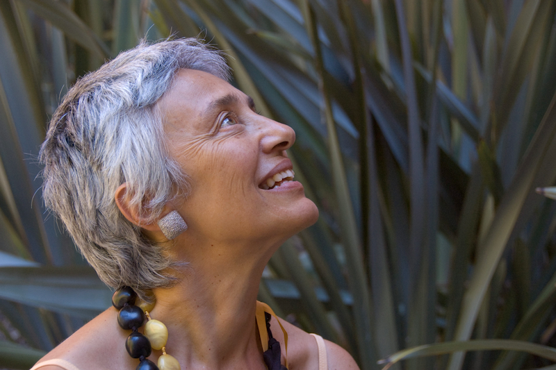 Closeup side view of Amelia Barili staring up at the sky